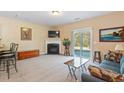 Comfortable living room featuring a fireplace, sliding glass door, and stylish furnishings for relaxed living at 2306 Stoney Spring Dr, Raleigh, NC 27610