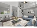 Staged living room featuring hardwood floors, high ceilings, and comfortable furniture at 2613 Coxindale Dr, Raleigh, NC 27615