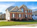 A charming two-story brick home with well-kept lawn and landscaping, featuring a side-entry garage at 2720 Stratford Hall Dr, Raleigh, NC 27614