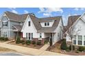 Charming two-story home featuring white siding, brick accents, and landscaped front yard at 308 Masden Rd, Holly Springs, NC 27540