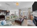 Cozy living room with fireplace, plush seating, and an open layout to kitchen and dining area at 308 Masden Rd, Holly Springs, NC 27540