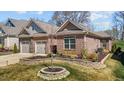 Charming single-Gathering home with a brick exterior, well-maintained lawn, and a two-car garage at 310 Macallan, Burlington, NC 27215