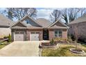 Charming single-Gathering home with a brick exterior, well-maintained lawn, and a two-car garage at 310 Macallan, Burlington, NC 27215