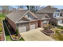 Brick house with a two-car garage and landscaped front yard with stone accents at 310 Macallan, Burlington, NC 27215