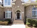 Inviting entryway featuring an arched doorway and elegant brick detailing at 314 Montelena Pl, Cary, NC 27513