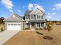 Beautiful home with a two-car garage, covered porch, manicured lawn, and gray color scheme at 316 Little Lady Trail, Zebulon, NC 27597