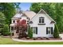 Charming two-story home featuring a lush landscaped yard, brick facade and inviting architectural details at 3421 Griffice Mill Rd, Raleigh, NC 27610