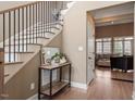 Bright foyer with hardwood floors, staircase, console table, and view into the expansive living space at 3421 Griffice Mill Rd, Raleigh, NC 27610