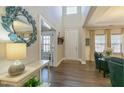 Bright and airy foyer with hardwood floors and a decorative mirror at 3508 Longleaf Estates Dr, Raleigh, NC 27616
