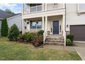 Inviting front entrance with stone steps, beautiful flowerbeds, and a well-manicured lawn at 421 Pine Burr St, Fuquay Varina, NC 27526