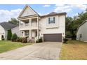 Beautiful two-story home with a covered porch, garage, and manicured lawn at 421 Pine Burr St, Fuquay Varina, NC 27526