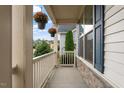 Cozy front porch with hanging flower baskets and view of the landscaped yard at 421 Pine Burr St, Fuquay Varina, NC 27526