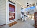 Cozy front porch with rocking chairs, ceiling fan, and a 'welcome' mat at 4443 Crystal Breeze St, Raleigh, NC 27614