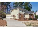 Rear view of home and driveway, showing siding, brick details, and ample parking space at 509 Edgemore Ave, Cary, NC 27519