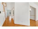 Bright foyer with gleaming hardwood floors, featuring a staircase and high ceilings at 509 Edgemore Ave, Cary, NC 27519