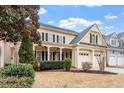 Charming two-story home with a welcoming front porch, two-car garage, and nicely manicured landscaping at 5102 Highcroft Dr, Cary, NC 27519