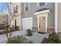 Townhome exterior with neutral siding, white garage door, and a welcoming front entrance at 515 Autumn Cure Ct, Fuquay Varina, NC 27526