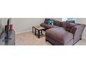 Cozy living room with a comfortable sectional sofa and stylish decor at 515 Autumn Cure Ct, Fuquay Varina, NC 27526