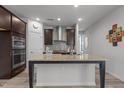 Open kitchen featuring an island, granite countertops, stainless appliances, and dark wood cabinets at 5212 Huntley Overlook Dr, Durham, NC 27703