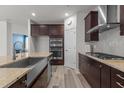 Modern kitchen boasts stainless steel appliances, granite countertops, and dark wood cabinetry at 5212 Huntley Overlook Dr, Durham, NC 27703