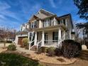 Inviting two-story house with a covered porch, manicured landscaping, and a welcoming entrance at 61 Langdon Pointe Dr, Garner, NC 27529