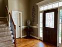 Elegant foyer with hardwood floors, a staircase, and a front door with sidelights at 61 Langdon Pointe Dr, Garner, NC 27529