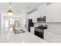 Bright kitchen features white cabinets, stainless appliances, and a spacious island at 6434 Astor Elgin St, Raleigh, NC 27616