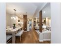 Open concept layout featuring hardwood floors connecting the modern kitchen, dining area, and cozy living room at 700 Bishops Park Dr # 205, Raleigh, NC 27605