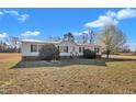 Attractive single-level home with a metal roof, neatly trimmed hedges, and a well-maintained lawn at 71 Oak Trace Dr, Four Oaks, NC 27524