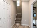 Inviting entryway with stairs and wood flooring, showcasing a bright and modern interior at 730 Firebrick Drive Dr, Cary, NC 27519
