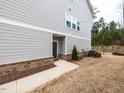 A modern home with gray siding, brick accents, and a well-maintained lawn at 730 Firebrick Drive Dr, Cary, NC 27519
