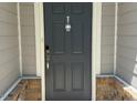 Stylish gray front door with a modern design and keyless entry at 730 Firebrick Drive Dr, Cary, NC 27519