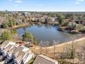 Picturesque aerial view of a community nestled around a serene lake, showcasing natural beauty at 8008 Upper Lake Dr, Raleigh, NC 27615