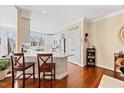 Open concept kitchen featuring a large island with bar seating and modern finishes at 8008 Upper Lake Dr, Raleigh, NC 27615
