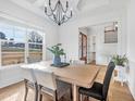 Elegant dining room with large windows, chandelier, and hardwood floors at 8201 Southmoor Hill Trl, Wake Forest, NC 27587