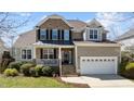 Beautiful home with stone accents, a covered porch, and an attached two-car garage at 9117 Cornwell Dr, Wake Forest, NC 27587