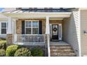 Cozy front porch with stone accents, comfortable seating, and a welcoming entrance at 9117 Cornwell Dr, Wake Forest, NC 27587
