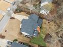 An aerial view of the home showing roof, landscaping, backyard deck, and surrounding neighborhood at 102 Caymus Ct, Cary, NC 27519
