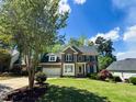 Charming brick home with lush green lawn and two-car garage at 102 Caymus Ct, Cary, NC 27519