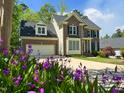 Charming brick home with lush green lawn and two-car garage at 102 Caymus Ct, Cary, NC 27519