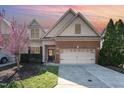 Charming two-story home with a brick and shingle facade, well-maintained lawn, and a two-car garage at 109 Aisling Ct, Cary, NC 27513