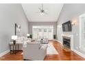 Spacious living room with a fireplace, hardwood floors, high ceilings, and ample natural light at 109 Aisling Ct, Cary, NC 27513