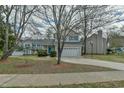 Traditional two-story home with light gray siding, blue shutters, and a spacious two-car garage at 110 Sudbury Ln, Chapel Hill, NC 27516