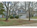 Traditional two-story home with a well-manicured lawn and a two-car garage at 110 Sudbury Ln, Chapel Hill, NC 27516