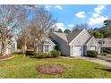 Charming home with a two-car garage, well-manicured lawn, and mature landscaping creates inviting curb appeal at 113 Duchess Ln, Chapel Hill, NC 27517