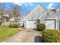 Charming home with a two-car garage, well-manicured lawn, and mature landscaping creates inviting curb appeal at 113 Duchess Ln, Chapel Hill, NC 27517