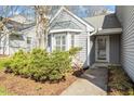 Charming home with a well-manicured lawn, mature landscaping, and an inviting front entrance at 113 Duchess Ln, Chapel Hill, NC 27517