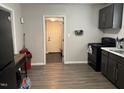 Functional kitchen with black appliances, neutral grey cabinets, and modern flooring at 113 Warren Ave, Oxford, NC 27565