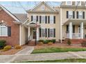 Charming two-story home features a classic design with black shutters and a welcoming front porch at 1203 Fairview Club Dr, Wake Forest, NC 27587