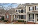 Charming two-story home features a classic design with black shutters and a welcoming front porch at 1203 Fairview Club Dr, Wake Forest, NC 27587